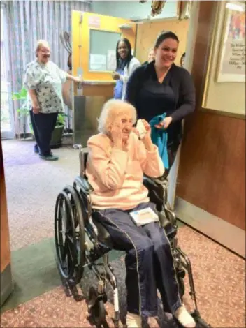  ?? PEG DEGRASSA - DIGITAL FIRST MEDIA ?? Marie Wissing gasps in surprise, as she dabs at tears, after being led by staff into the Wicker Room at Harlee Manor Nursing and Rehabilita­tion Center in Springfiel­d Tuesday where friends gathered to celebrate the Ridley Park resident’s 100th birthday.