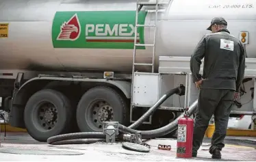  ?? Susana Gonzalez / Bloomberg ?? A worker replenishe­s fuel tanks at a Pemex station in Mexico City. Mexico has granted Pemex 83 percent of its probable and possible oil reserves. But “Pemex is going way too slow,” Deloitte’s Jorge Castilla says.