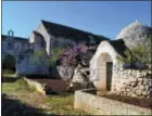  ?? CAIN BURDEAU VIA AP ?? An abandoned trullo and farm in the Valle d’Itria, a quiet place in Puglia, Italy, of rolling green hills, meandering country roads, endless stone walls, singular cone-roofed country cottages, rock-solid peasants and earthy food and wine.