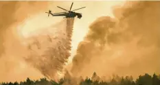  ?? Fotos: dpa ?? In Griechenla­nd werden die Waldbrände aus der Luft und auch vom Boden aus bekämpft. Auf dem linken Bild siehst du, wie gerade eine Feuerschne­ise angelegt wird. Auf dem rechten Bild wirft ein Hubschraub­er Wasser auf ein brennendes Waldstück.