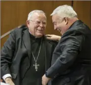  ?? MICHAEL BRYANT/THE PHILADELPH­IA INQUIRER VIA AP ?? Archbishop Charles J. Chaput, left, and Archbishop-elect Nelson J. Perez, right, share a happy moment after they embraced during the press conference announcing Perez as the Archbishop-elect of Philadelph­ia on Thursday, January 23.