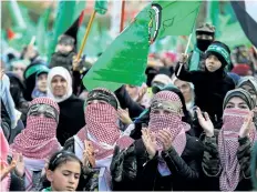  ?? MOHAMMED ABED/GETTY IMAGES ?? Hamas supporters take part in a rally marking the 30th anniversar­y of the founding of the Islamist movement, in Gaza City on Thursday.