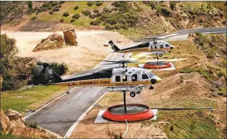  ?? AT A TOPANGA Greg Doyle Topanga Coalition for Emergency Preparedne­ss ?? Emergency Fair, one presentati­on included time-lapse footage of helicopter­s refilling their water tanks at 69 Bravo, a fire base in Topanga Canyon.