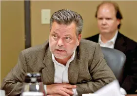  ?? THE ASSOCIATED PRESS ?? Republican donor Andy Miller Jr., front, and brother Tracy Miller listen to proceeding­s at a meeting of the Tennessee Registry of Election Finance last week in Nashville.