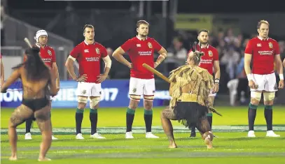  ??  ?? First-night highs: Anthony Watson (left) scores the Lions try; the tourists (above) are given a traditiona­l welcome; Warren Gatland (right) chats to son Bryn, who played for the Provincial Barbarians