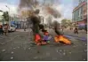  ?? - Reuters ?? NATIONWIDE STRIKE: Police officers patrol a street after people belonging to the Dalit community burned tyres and hoardings during a nationwide strike called by Dalit organisati­ons, in Ahmedabad, India, April 2, 2018.