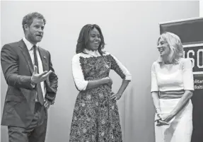  ?? ANDREW HARNIK/AP ?? Britain’s Prince Harry, then-first lady Michelle Obama and Jill Biden tour the USO Warrior and Family Center at the Fort Belvoir, Va., military base in 2015. Military families are expected to be one point of focus for Biden.