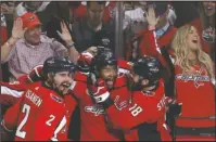  ?? The Associated Press ?? CAPITALIZA­TION: Forward Devante Smith-Pelly, center, celebrates his goal against the Vegas Golden Knights with teammates Matt Niskanen, left, and Chandler Stephenson, Saturday during the third period of the Capitals’ 3-1 victory in Game 3 of the NHL...