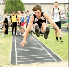  ?? RICK PECK/MCDONALD COUNTY PRESS ?? McDonald County freshman Jack Teague flies through the air with a leap of 18-7 in long jump to take fifth place at the East Newton Relays held April 13 at East Newton High School.