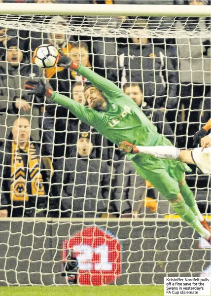  ??  ?? Kristoffer Nordfelt pulls off a fine save for the Swans in yesterday’s FA Cup stalemate