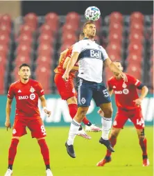  ?? KEVIN SOUSA/USA TODAY SPORTS ?? Whitecaps defender Ali Adnan heads the ball against Toronto FC during the Reds’ 3-0 win at BMO Field.