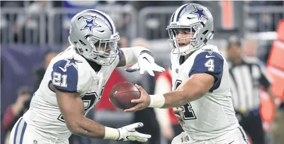  ??  ?? Dallas quarterbac­k Dak Prescott, right, hands the ball off to Ezekiel Elliott during a recent game.