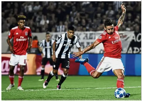  ??  ?? Poised for a win: Benfica’s Eduardo Salvio shoots to score a penalty and his side’s second goal during the Champions League second-leg playoff against PAOK on Wednesday. — AP