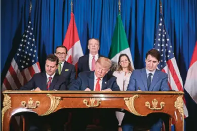  ??  ?? Then Mexican President Enrique Peña Nieto, US President Donald Trump, and Canadian Prime Minister Justin Trudeau sign the United States-mexico-canada Agreement, which replaces the North American Free Trade Agreement, during the G20 summit in Buenos Aires, Argentina, on November 30, 2018.