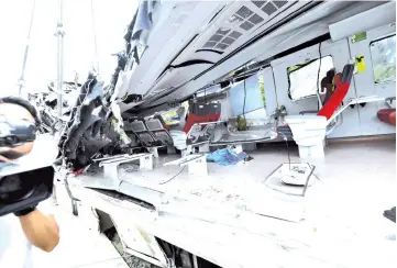  ??  ?? A journalist videos the damaged Puyuma Express train. — AFP photo