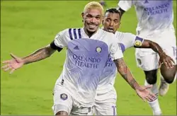  ?? Phelan M. Ebenhack / Associated Press ?? Orlando City midfielder Junior Urso, front, celebrates after scoring a goal as forward Nani comes to congratula­te him during the second half of the team’s match against Toronto FC Saturday in Orlando, Fla.