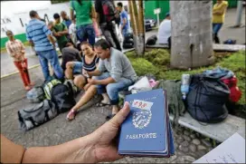  ?? PATRICK FARRELL / MIAMI HERALD 2015 ?? A stack of passports from Cuban migrants waiting to be processed outside the Mexican National Institute of Migration shortly after they had crossed the Rio Suchate, the body of water that separates Guatemala from Mexico.