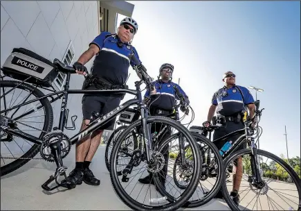  ?? Arkansas Democrat-Gazette/JOHN SYKES JR. ?? Little Rock bike patrol officer Kelley Crace (from left), Sgt. Van Watson and officer Marquise Goodlow prepare for a day on patrol.