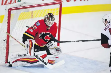  ??  ?? Arizona Coyotes’ Jordan Martinook beats Flames goalie Chad Johnson during the second period Monday night in Calgary.