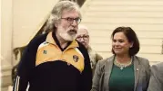  ?? MICHAEL COOPER AP ?? Sinn Fein President Mary Lou McDonald, background, walks with former President Gerry Adams after the power sharing assembly in Northern Ireland was restored at Parliament Buildings, Stormont, in Belfast, Northern Ireland, on Saturday.