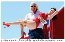  ?? ?? Airline founder: Richard Branson holds burlesque dancer Dita Von Teese dressed as the Flying Lady in 2010