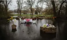  ??  ?? The table is all set for dinner in one resident’s flooded back yard.