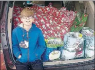  ?? (Courtesy Photo) ?? Jaxton Jowers, 11, of Farmington sits in front of Christmas presents he’s delivering to the residents at Peachtree Village in Farmington.