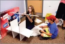  ?? PHOTO BY RACHEL TWOGUNS ?? MEMBERS OF THE Kids CuddleKit Closet Youth Board spent their Saturday morning creating a special area just for children at the Crossroads Mission family shelter. Here, Garvey Blackwell (left) and Easton Sheppeard work on some shelving.