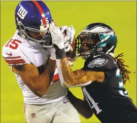  ?? Mitchell Leff Getty I mages ?? GOLDEN TATE ( 15) secures a touchdown catch against Cre’Von LeBlanc of the Eagles at Lincoln Financial Field, where Philadelph­ia rallied from a 21- 10 score.