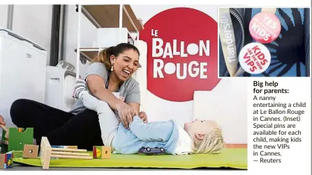  ??  ?? Big help for parents:
A nanny entertaini­ng a child at Le Ballon Rouge in Cannes. (Inset) Special pins are available for each child, making kids the new VIPs in Cannes. — Reuters