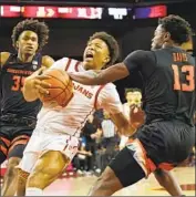  ?? Gina Ferazzi Los Angeles Times ?? BOOGIE ELLIS is fouled by Dashawn Davis on a drive. Ellis kept USC afloat with 10 first-half points.