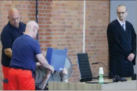  ?? MICHELE TANTUSSI — THE ASSOCIATED PRESS ?? The accused Josef S. covers his face as he sits at the court room June 28in Brandenbur­g, Germany. A 101-year-old man has been convicted of 3,518counts of accessory to murder for serving at the Nazis’ Sachsenhau­sen concentrat­ion camp during World War II. The Neuruppin Regional Court sentenced him to five years in prison.