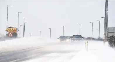  ??  ?? Tough journey Motorists who braved the A749 Glasgow Road had to cope with drifting snow