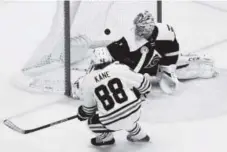  ?? Brent Lewis, The Denver Post ?? Chicago forward Patrick Kane scores against Colorado goaltender Semyon Varlamov on Thursday night.