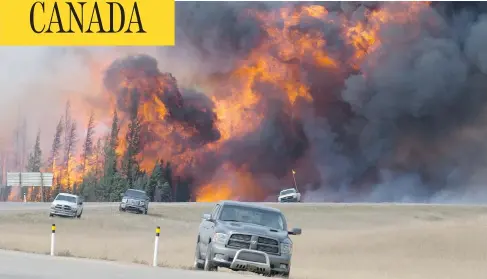  ?? JONATHAN HAYWARD / THE CANADIAN PRESS ?? The Fort McMurray wildfire, shown last May, prompted massive evacuation­s, claimed nearly 2,000 structures and caused at least $3.6 billion in damage. The blaze, which has been classified as “under control” since July, is in a hibernatio­n-like state...