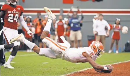  ?? ROB KINNAN/USA TODAY SPORTS ?? Clemson quarterbac­k Kelly Bryant dives for a touchdown during the first half against North Carolina State at Carter-Finley Stadium on Saturday.