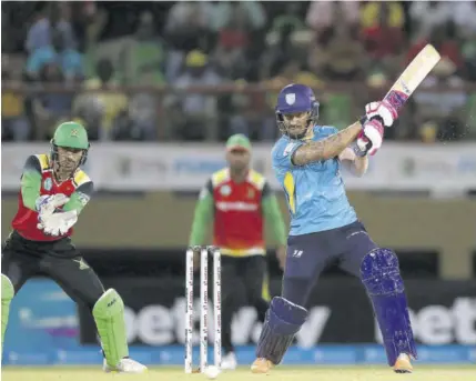  ?? ?? Faf du Plessis (right) of St Lucia Kings hits a four as Rahmanulla­h Gurbaz of Guyana Amazon Warriors looks on during the Men’s 2022 Hero Caribbean Premier League match at Providence Stadium on Thursday.