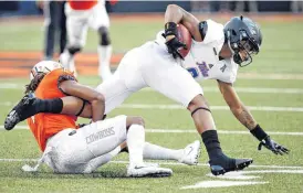  ?? [PHOTO BY NATE BILLINGS, THE OKLAHOMAN] ?? Ramon Richards stops Keenen Johnson during Thursday night’s game in Stillwater.