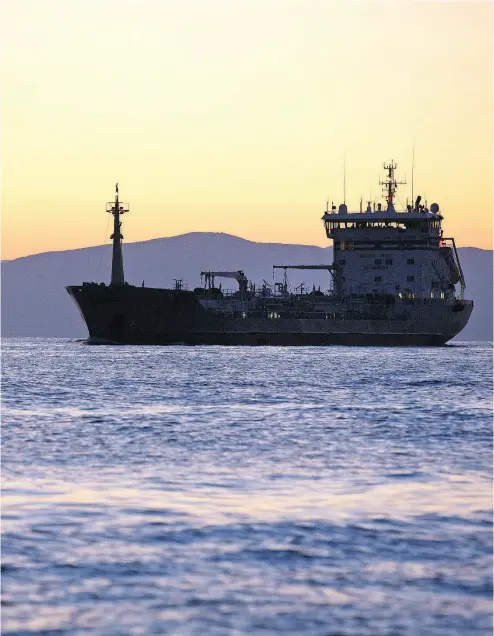  ?? ANDREY RUDAKOV / BLOOMBERG FILES ?? A cargo vessel passes through the Eastern Bosphorus strait in Vladivosto­k, Russia.
