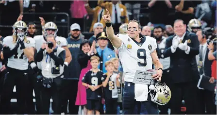  ?? BUTCH DILL THE ASSOCIATED PRESS ?? Saints quarterbac­k Drew Brees (9) responds to the crowd after breaking the National Football League all-time passing yards record in the first half against the Washington Redskins in New Orleans on Monday night. Brees set the record with a 62-yard touchdown pass to rookie Tre’Quan Smith.