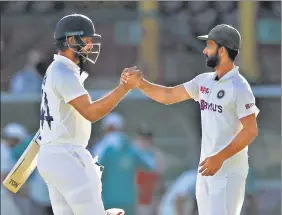  ?? GETTY ?? Hanuma Vihari shakes hands with Ajinkya Rahane after India secured a draw on Monday.