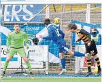  ??  ?? Euan East (centre) scores Queen of the South’s second goal