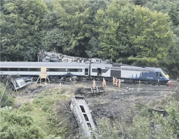  ??  ?? 0 The train derailed at Carmont last August after it hit stones washed onto the tracks by heavy rain