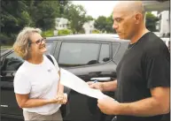  ?? Brian A. Pounds / Hearst Connecticu­t Media ?? Republican Kathy Kennedy, of Milford, hands a petition to supporter Al Corsi as she campaigns in his Milford neighborho­od on July 15. Kennedy is running for state representa­tive from the 119th district, representi­ng Milford and Orange.