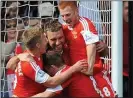  ??  ?? SAINTS AND WINNERS: Rickie Lambert is mobbed after scoring