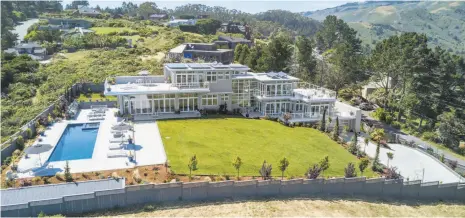  ?? Photos by Circle Visions ?? Above: The property at 36 Starbuck Drive in Muir Beach is available for $11.7 million. A pool and spa look out at the Muir Beach landscape and ocean. Top right: The great room features a glass fireplace and opens to a pool patio. Bottom right: The...