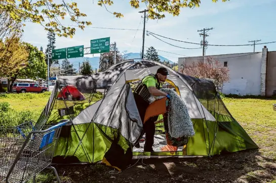  ?? Photos by Gabrielle Lurie/The Chronicle ?? A community service officer clears a tent from Riverside Park in Grants Pass, Ore., after the tent’s owner was arrested. The small city is at the center of a pivotal case on homelessne­ss policies that is about to be taken up by the U.S. Supreme Court.