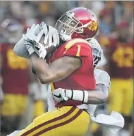  ?? Robert Gauthier Los Angeles Times ?? USC RECEIVER Darreus Rogers wraps up one of his four catches while Oregon’s Arrion Springs wraps him up.