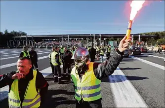  ??  ?? En tenue de travail, casque de feu sur la tête et gilet jaune sur le dos, les sapeurs-pompiers ont investi les voies de la grande barrière de péage d’Antibes, en direction d’Aix. Hier soir, les derniers « gilets jaunes » ont été délogés par la police. (Photo Eric Ottino)