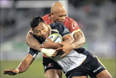  ??  ?? Lionel Mapoe, behind, of the Lions tackles Aidan Toua of the Brumbies during their Super Rugby match at GIO Stadium in Canberra, Australia, yesterday. The visitors eked out a tough victory to remain strongly in contention for a home play-off.